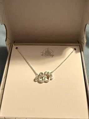NWT Disney Parks jewelry. Mickey & Minnie intertwined on a necklace
